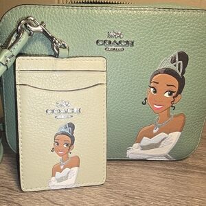 Disney X Coach Mini Camera Bag and Lanyard With Tiana.